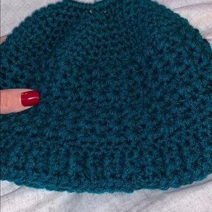 Dark teal adult size messy bun crochet beanie.